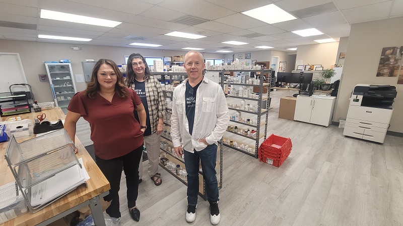 Three pharmacy staff pose in the New Narrative pharmacy.