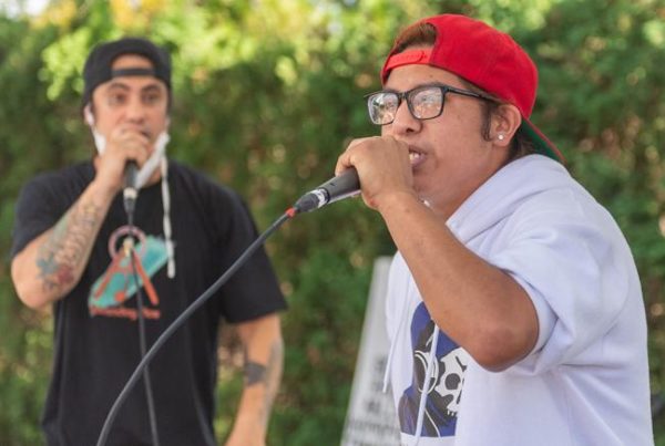 Lil B Raps (right), current Ascending Flow participant, performs at the Mill Park Community Block Party with Talilo Marfil (left). (Photo by Diego Diaz)