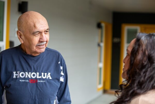 Curtis speaking with a staffer outside of his apartment home