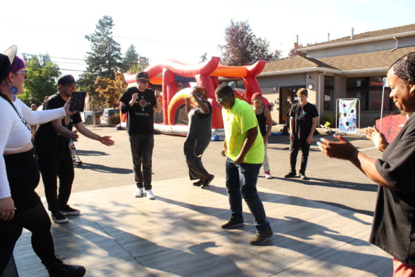 participants dancing on dance floor in parking lot