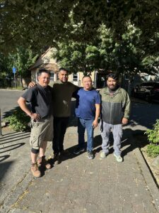 Four members of the maintenance crew. L-R: Roger Chau, Robert Conejo, PT, and Joe Palomares. They are standing outside.