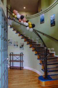 Entryway curved stairwell of Jade House featuring balloons