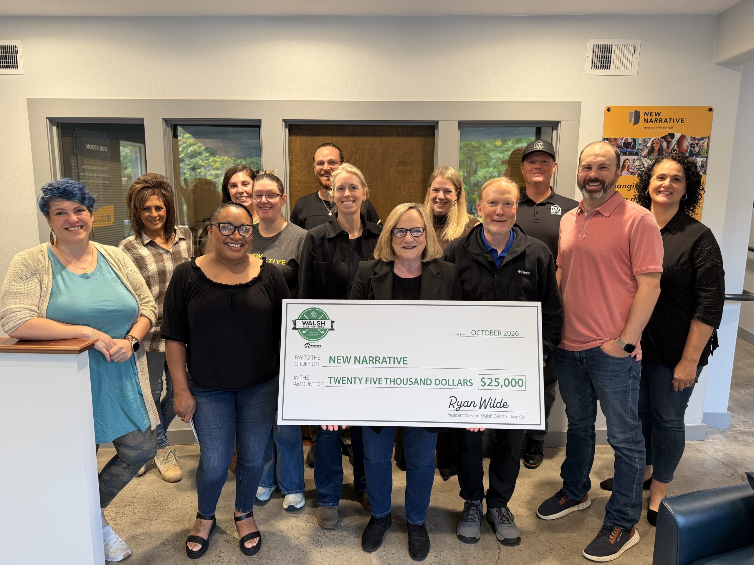 Community partners with a Walsh Construction presentation check for New Narrative.