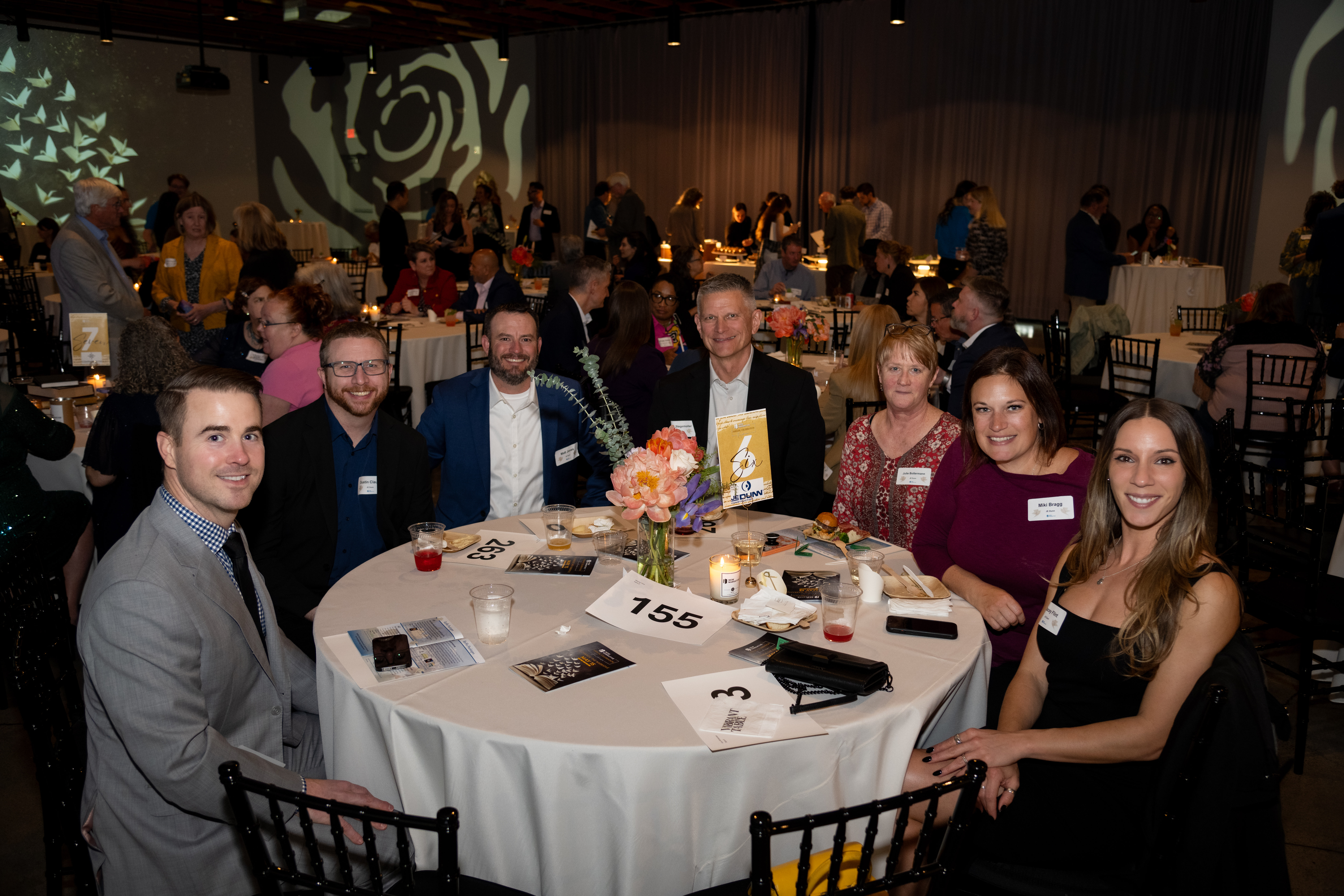 gala guests at a table posed