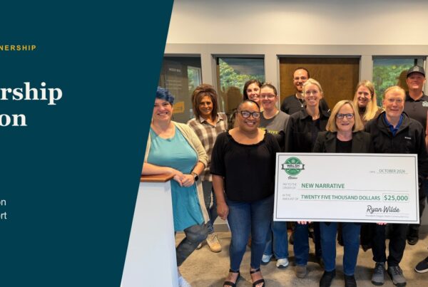 A group holds a Walsh Construction presentation check payable to New Narrative, framed with green and gold shapes.